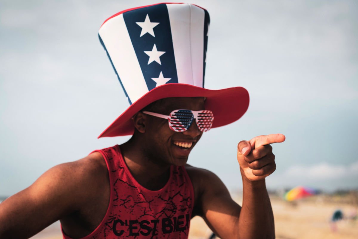 A man wearing a funny USA hat and glasses